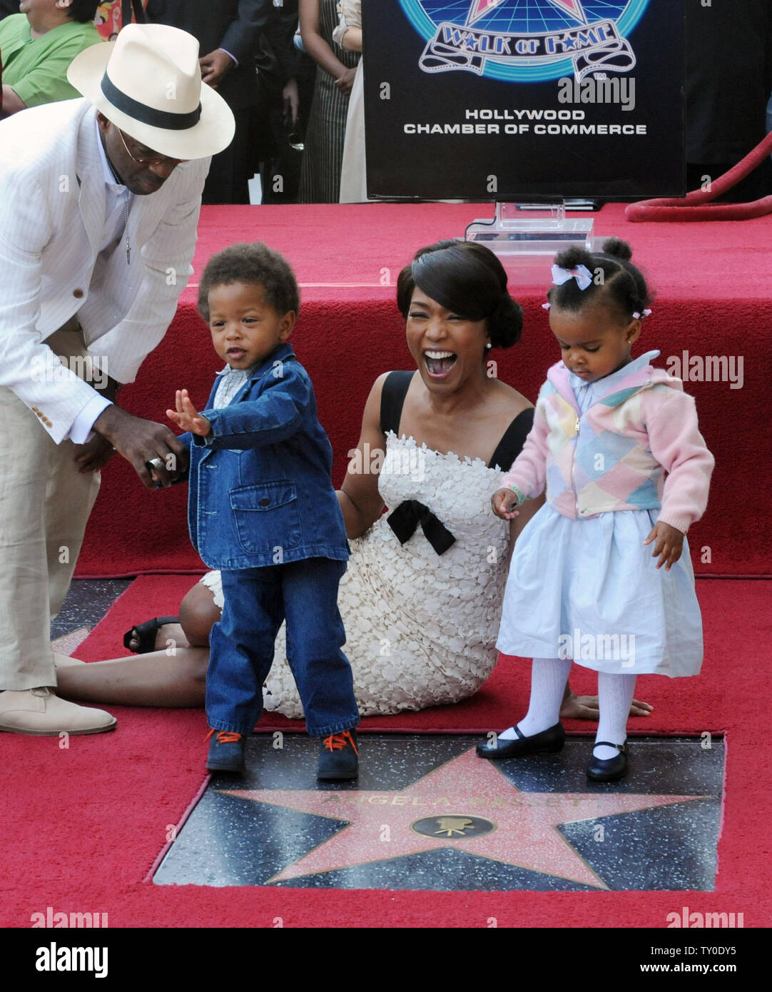 Actress Angela Bassett laughs as her son Slater Josiah and daughter Bronwyn Golden with actor Courtney B. Vance (L), walk on her star on the Hollywood Walk of Fame in Los Angeles on March 20, 2008. Bassett was the 2,358th celebrity to be honored with a star during an unveiling ceremony attended by family, fans and friends.  (UPI Photo/Jim Ruymen) Stock Photo