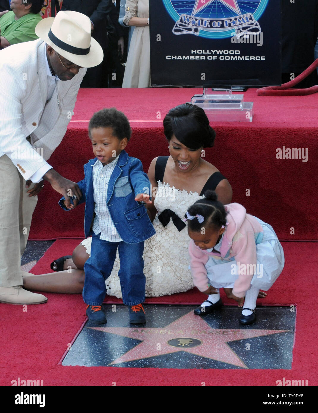 Actress Angela Bassett laughs as her son Slater Josiah and daughter Bronwyn Golden with actor Courtney B. Vance (L), walk on her star on the Hollywood Walk of Fame in Los Angeles on March 20, 2008. Bassett was the 2,358th celebrity to be honored with a star during an unveiling ceremony attended by family, fans and friends.  (UPI Photo/Jim Ruymen) Stock Photo