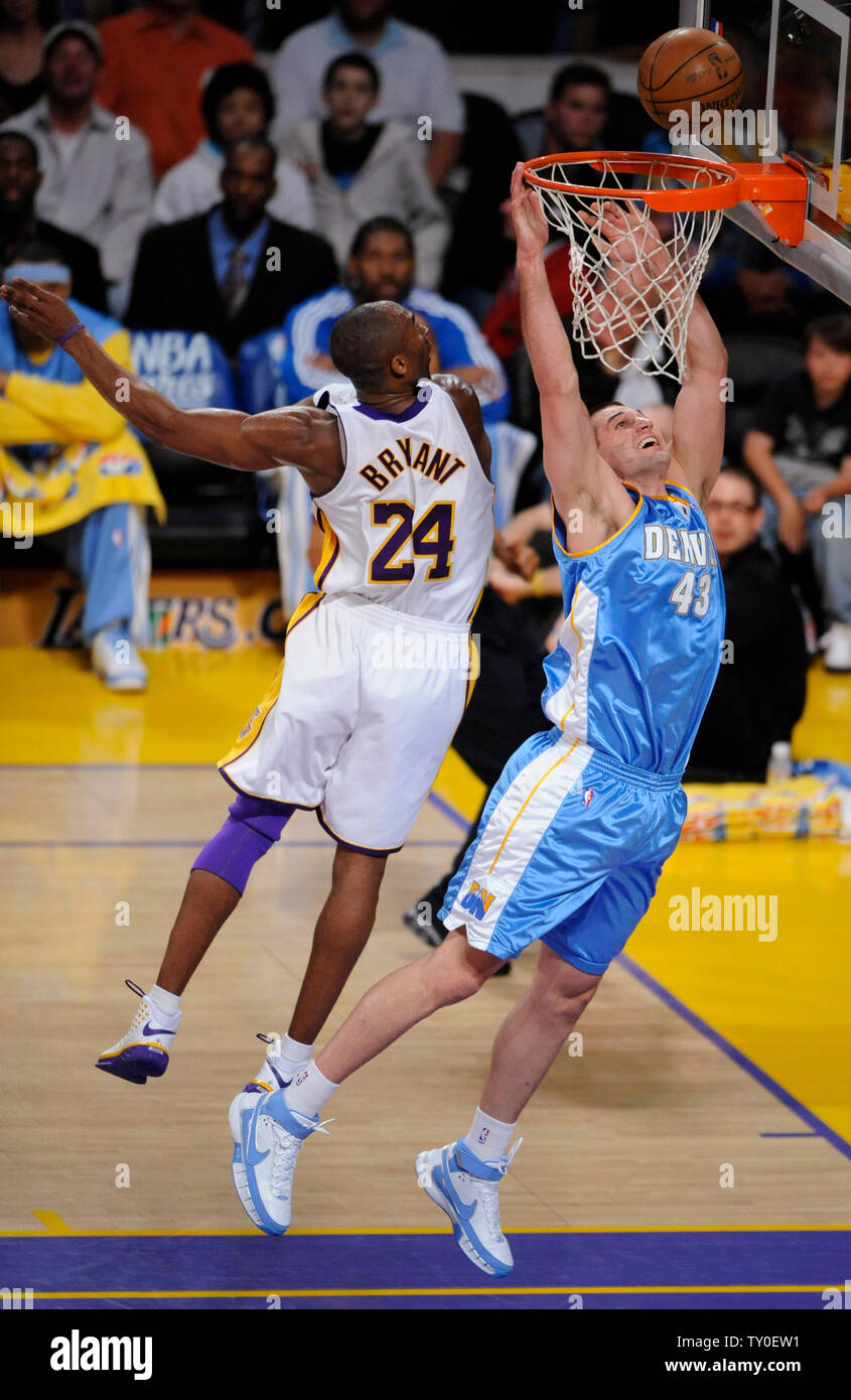 Los Angeles Lakers Kobe Bryant (L) defends as Denver Nuggets Linas Kleiza  goes to the basket during the first half of game one of the NBA playoffs  Western Conference first round in