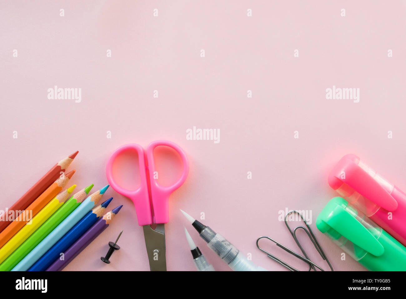 Office and school supplies on pink background. Free space Stock Photo