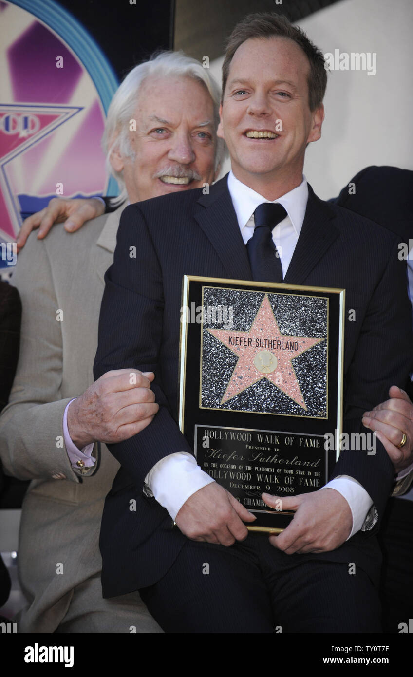 Kiefer Sutherland (R) sits on father Donald Sutherland's lap at the unveiling ceremony honoring Kiefer Sutherland with a star on the Hollywood Walk of Fame on December 9, 2008. (UPI Photo/ Phil McCarten) Stock Photo