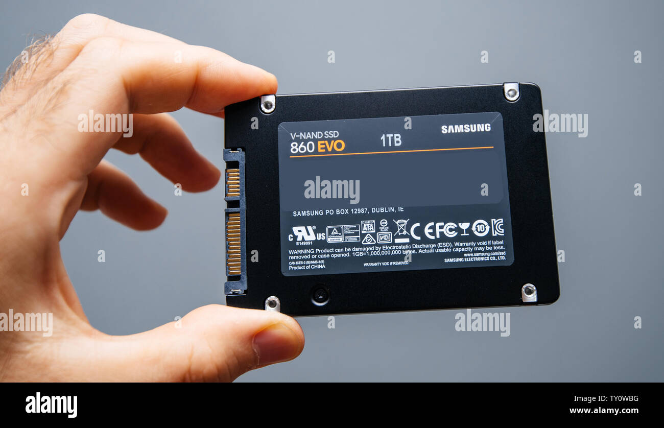 Paris France May 18 19 Man Hand Holding New Ssd Solid State Drive Disk From Samsung Model 860 Evo 1 Tb Fastest Flash Media Disk Gray Background Stock Photo Alamy