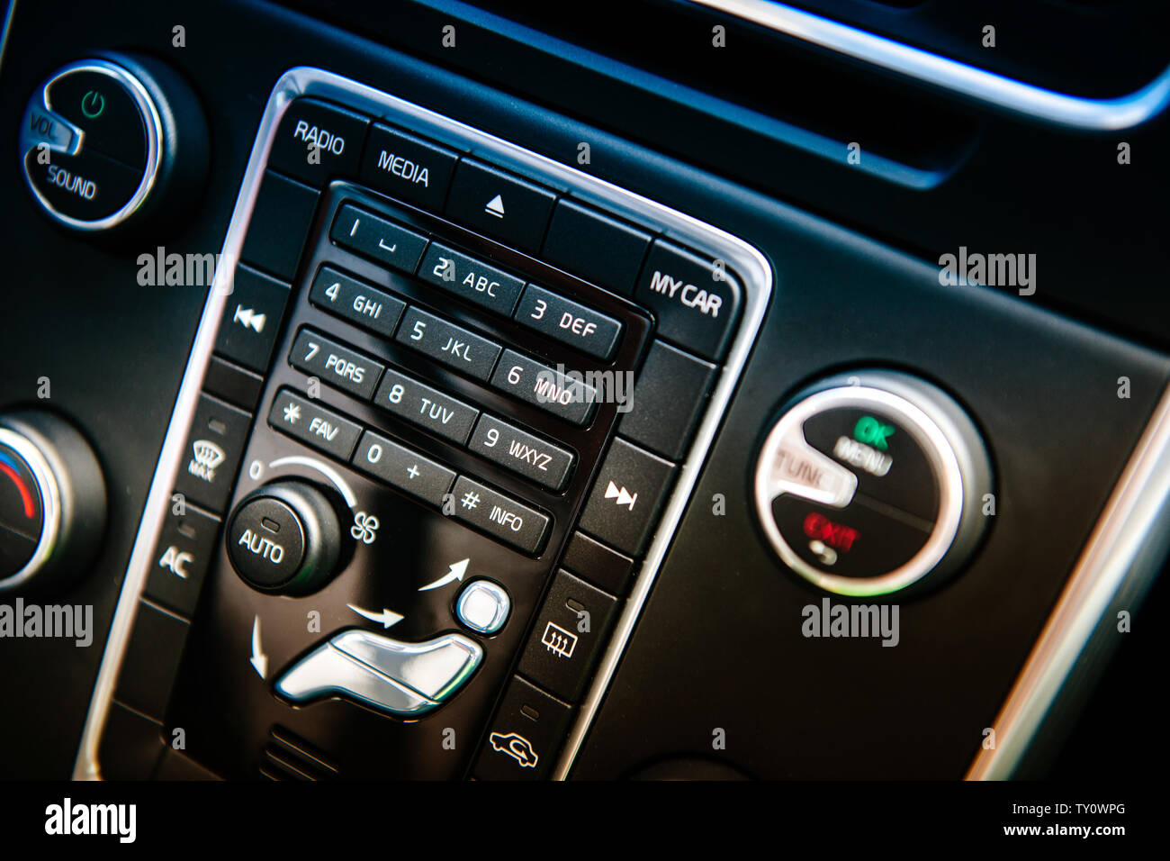 Side view of modern luxury car dashboard with control of the phone