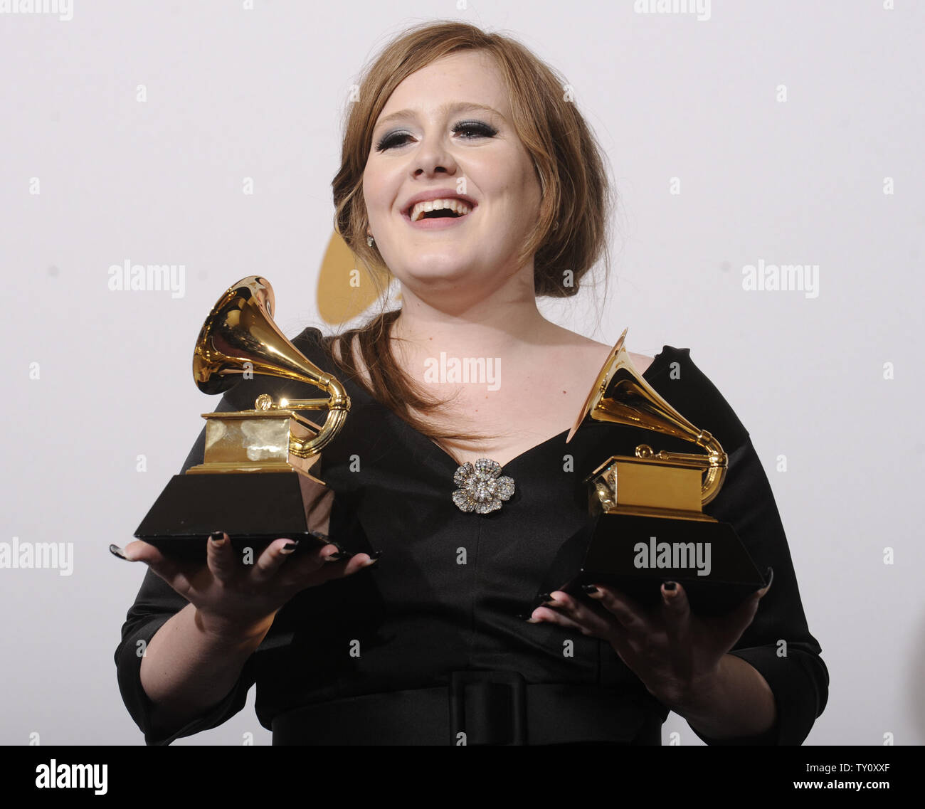 Adele holds her Grammy Awards for Best Female Pop Vocal 