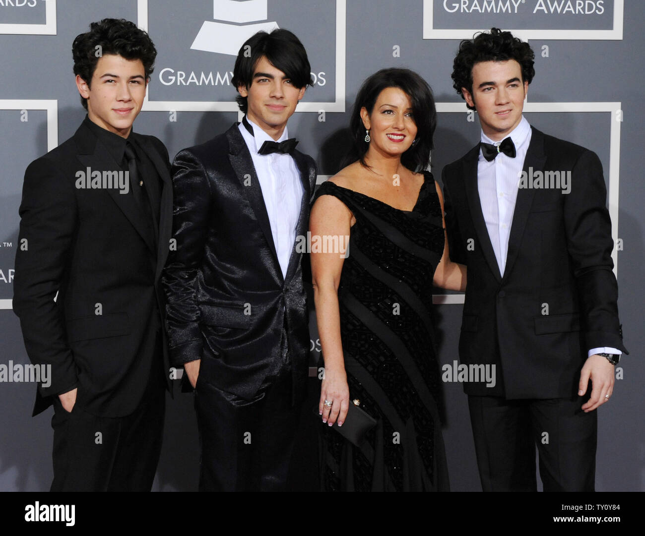 The Jonas Brothers arrive with their mother Denise Jonas for the 51st