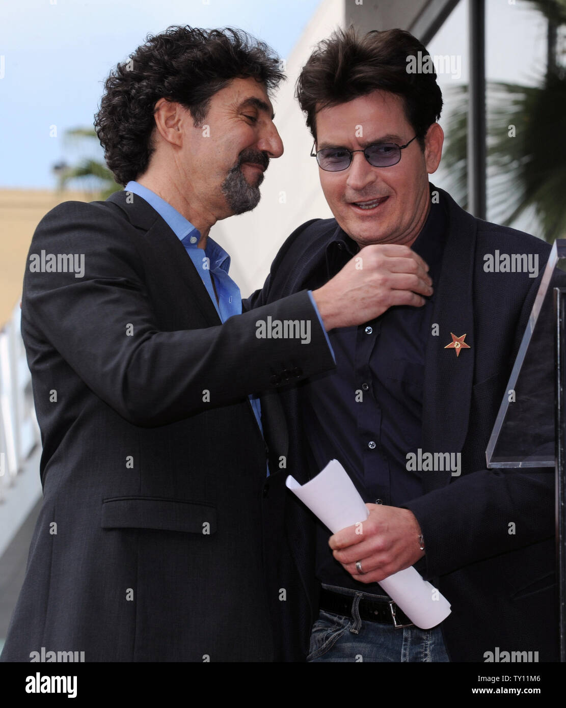 Chuck Lorre (L) is embraced by actor Charlie Shen during ceremonies honoring him with the 2,380th star on the Hollywood Walk of Fame in Los Angeles on March 12, 2009. Lorre produces and co-created CBS' 'The Big Bang Theory' and 'Two and Half Men'. He also produced 'Dharma & Greg'' and 'Grace Under Fire'. (UPI Photo/Jim Ruymen) Stock Photo
