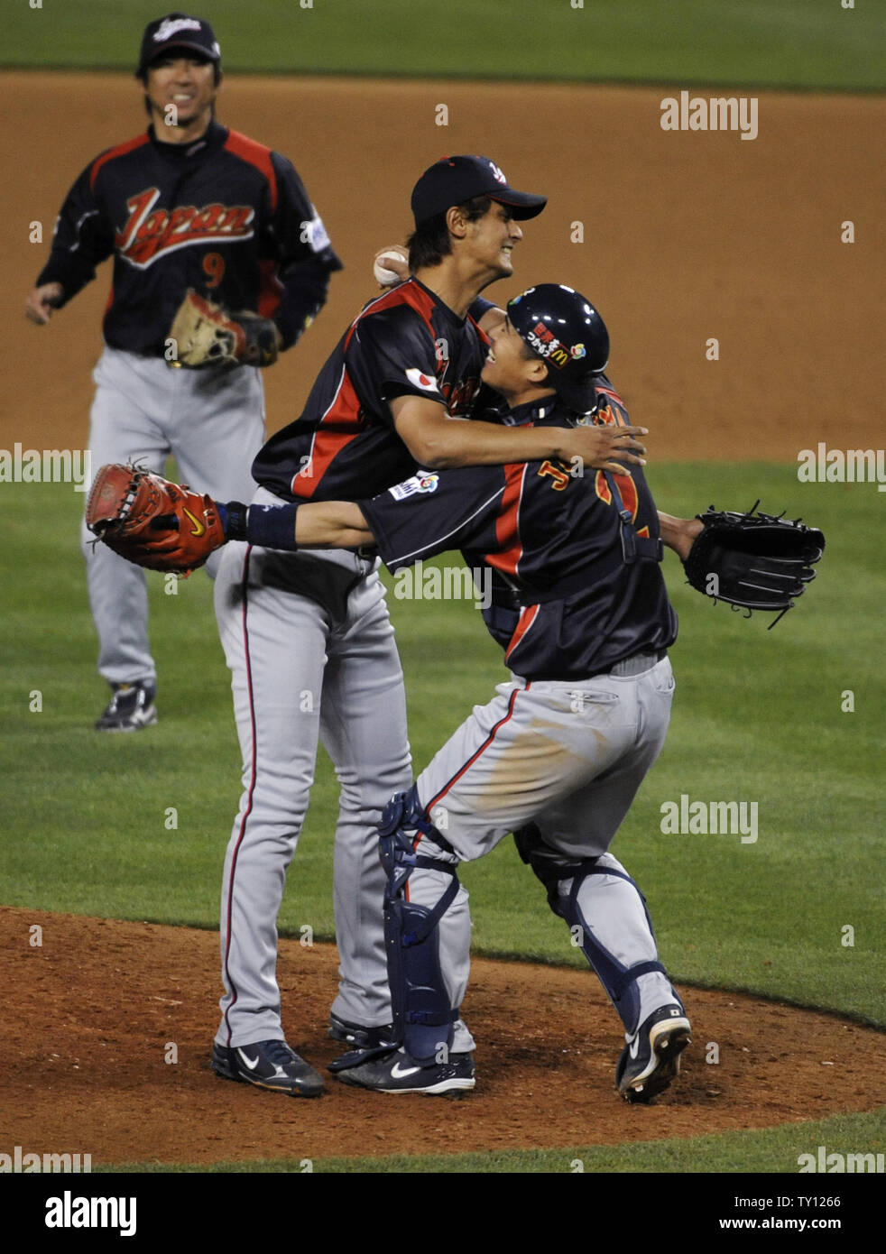 Japan's pitcher Yu Darvish (L) and catcher Kenji Johjima (R) celebrates ...