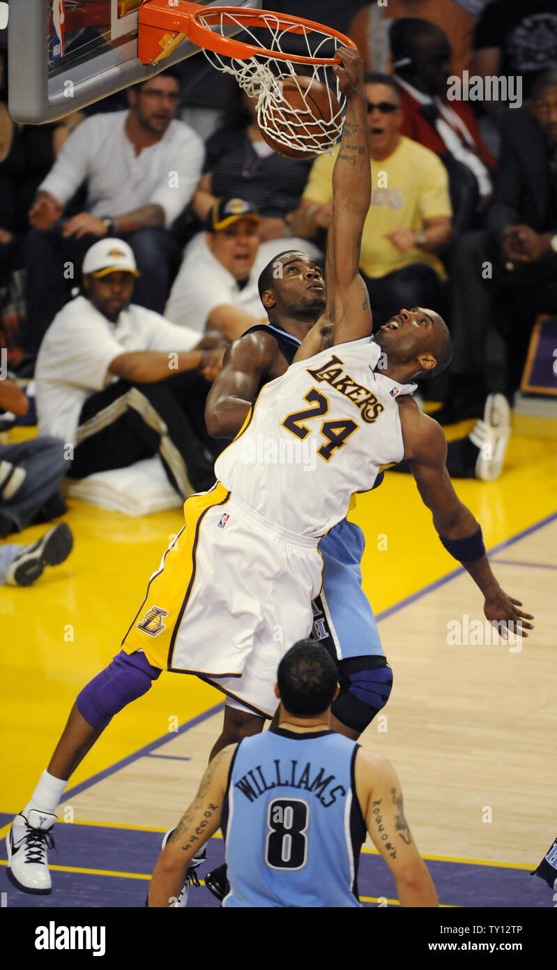 Los Angeles Lakers Kobe Bryant 24 dunks as the Utah Jazz s Paul Milsap defends during the second half of their NBA Western Conference First Round playoff game in Los Angeles on April
