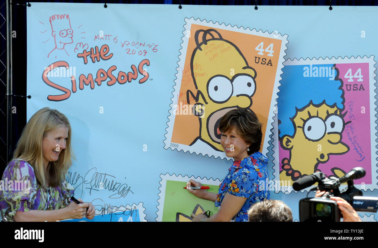Nancy Cartwright, the voice of Bart Simpson (L) and Yeardley Smith, the voice of Lisa Simpson, sign posters at the unveiling of the new 'The Simpsons' U.S. postage stamps in Los Angeles May 7, 2009. (UPI Photo/Jim Ruymen) Stock Photo