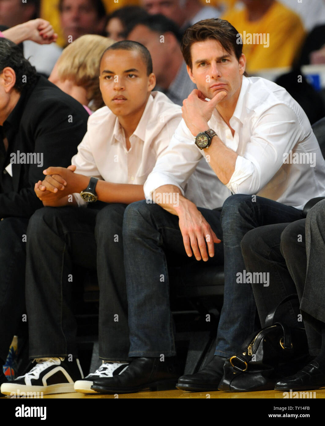 Actor Tom Cruise (R) sits courtside with his adopted son Connor as they(02)