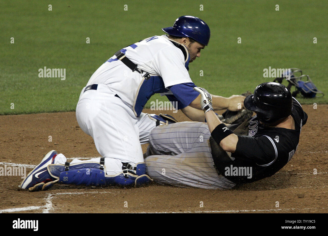 Los Angeles Dodgers catcher Russell Martin tags Colorado Rockies second