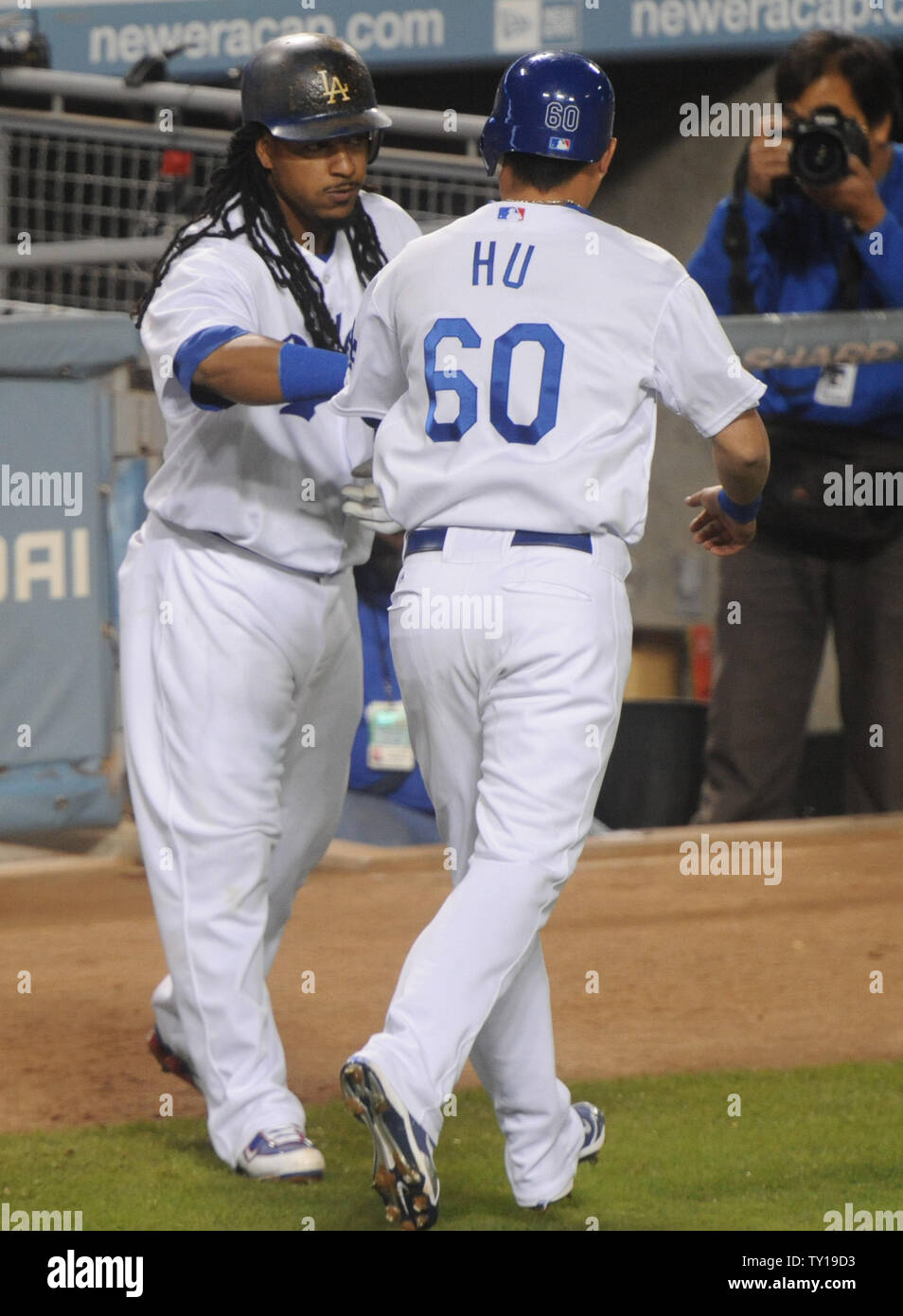 Los Angeles Dodgers' Manny Ramirez (99) celebrates with Chin-lung Hu (60) after Hu scored in the 5-run seventh inning against the Colorado Rockies in Los Angeles on October 3, 2009. The Dodgers went on to win the National League Western Division title in their Major League Baseball game against the Colorado Rockies in Los Angeles on October 3, 2009.     UPI/Jim Ruymen Stock Photo
