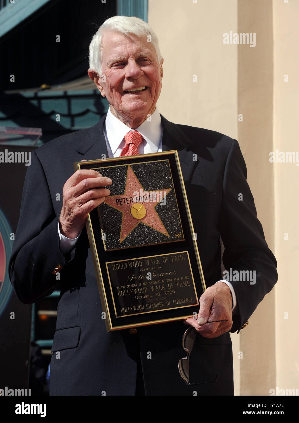 Actor Peter Graves holds a replica plaque during dedication ceremonies for Graves' star on the Hollywood Walk of Fame on October 30, 2009 in Los Angeles. His movie career spanned classics such as 'Stalag 17' to comedies such as 'Airplane!', but he is best remembered by many as the head of the 'Mission: Impossible' force in the 1960s and 70s.     UPI/Jim Ruymen. Stock Photo