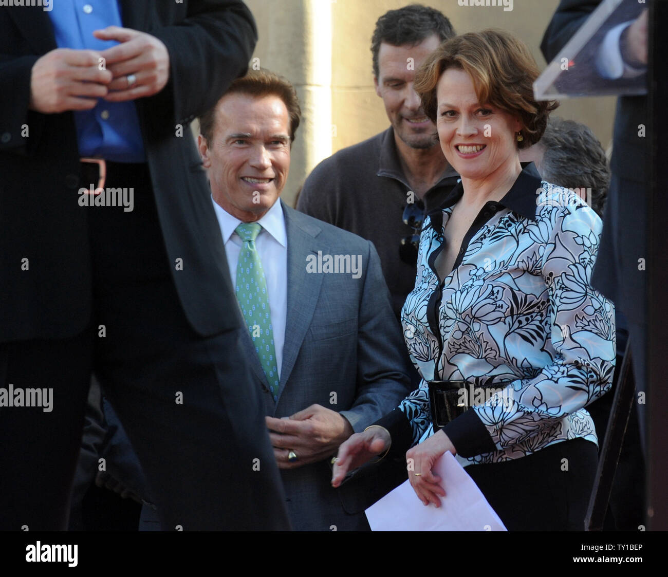 Actress Sigourney Weaver (L) and California Gov. Arnold Schwarzenegger wait to speak at the podium before director James Cameron was awarded a star on the Hollywood Walk of Fame in Los Angeles on December 18, 2009. Schwarzenegger starred in Cameron's 'Terminator' movies and Weaver was a cast member in his films 'Aliens' and the new 'Avatar'.      UPI/Jim Ruymen Stock Photo