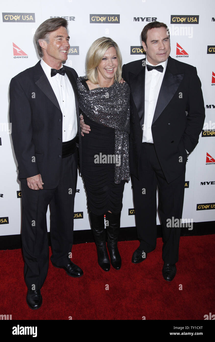 Olivia Newton-John (C), her husband John Easterling (L) and John Travolta arrive on the red carpet at the G'Day USA 2010 Los Angeles Black Tie Gala in Hollywood on January 16, 2010.  The event honors high profile individuals for significant contributions to their industries and for excellence in promoting Australia in the United States.   (UPI/David Silpa) Stock Photo