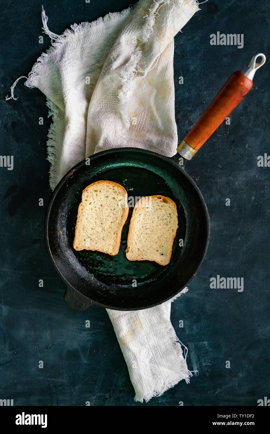 top view of frying bread toasts in the pan, the process of cooking fast