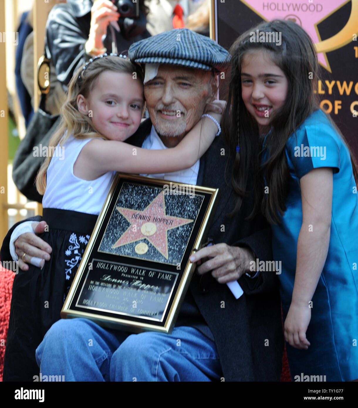 Actor Dennis Hopper is hugged by his daughter Galen (L) and his