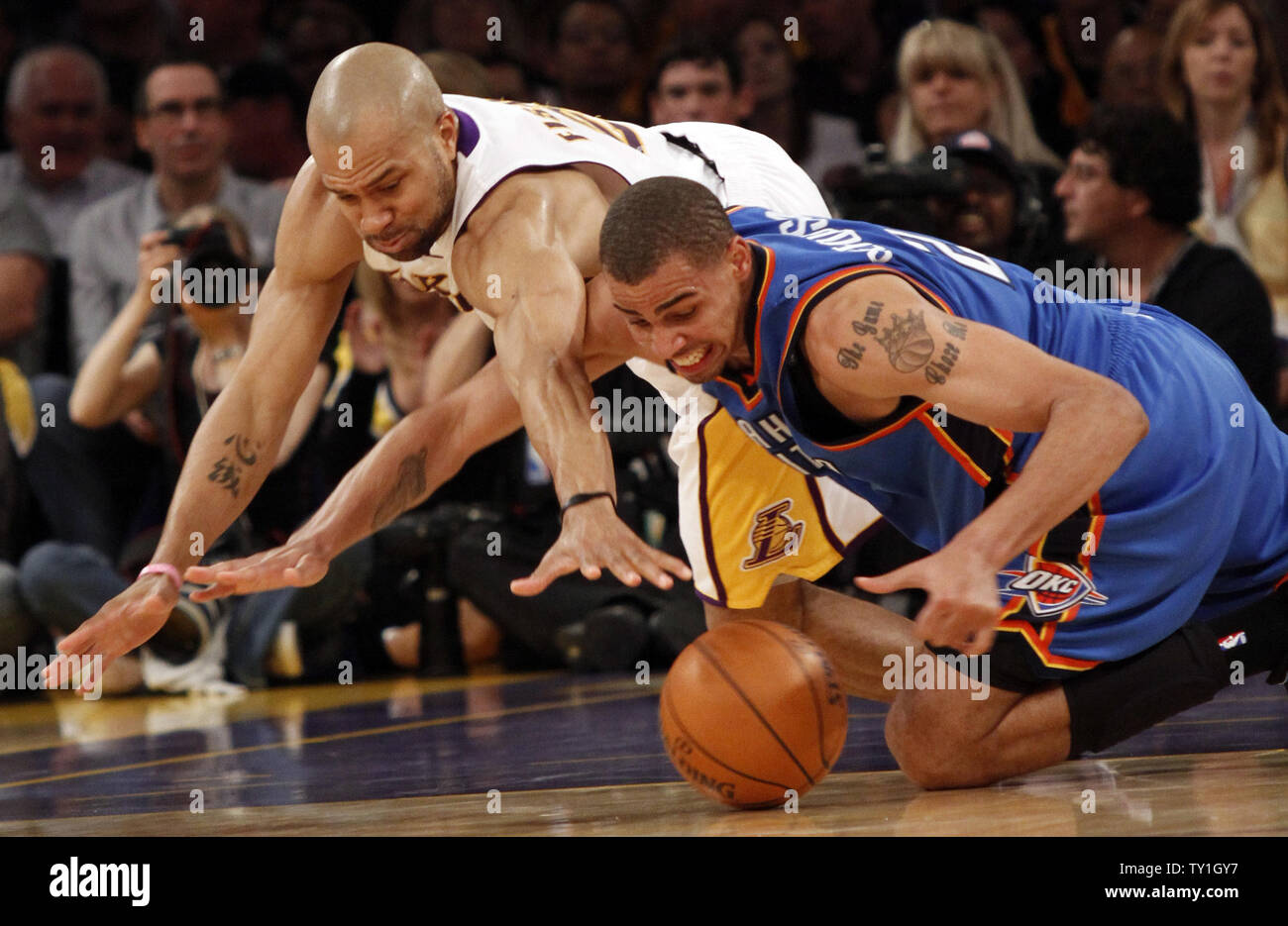 Los Angeles Lakers guard Derek Fisher (L) and Oklahoma City Thunder guard Thabo Sefolosha go for a loose ball during the first half of Game 1 of their Western Conference playoff series at Staples Center in Los Ageles on April 18, 2010. The Lakers defeated the Thunder 87-79.  UPI Photo/Lori Shepler Stock Photo