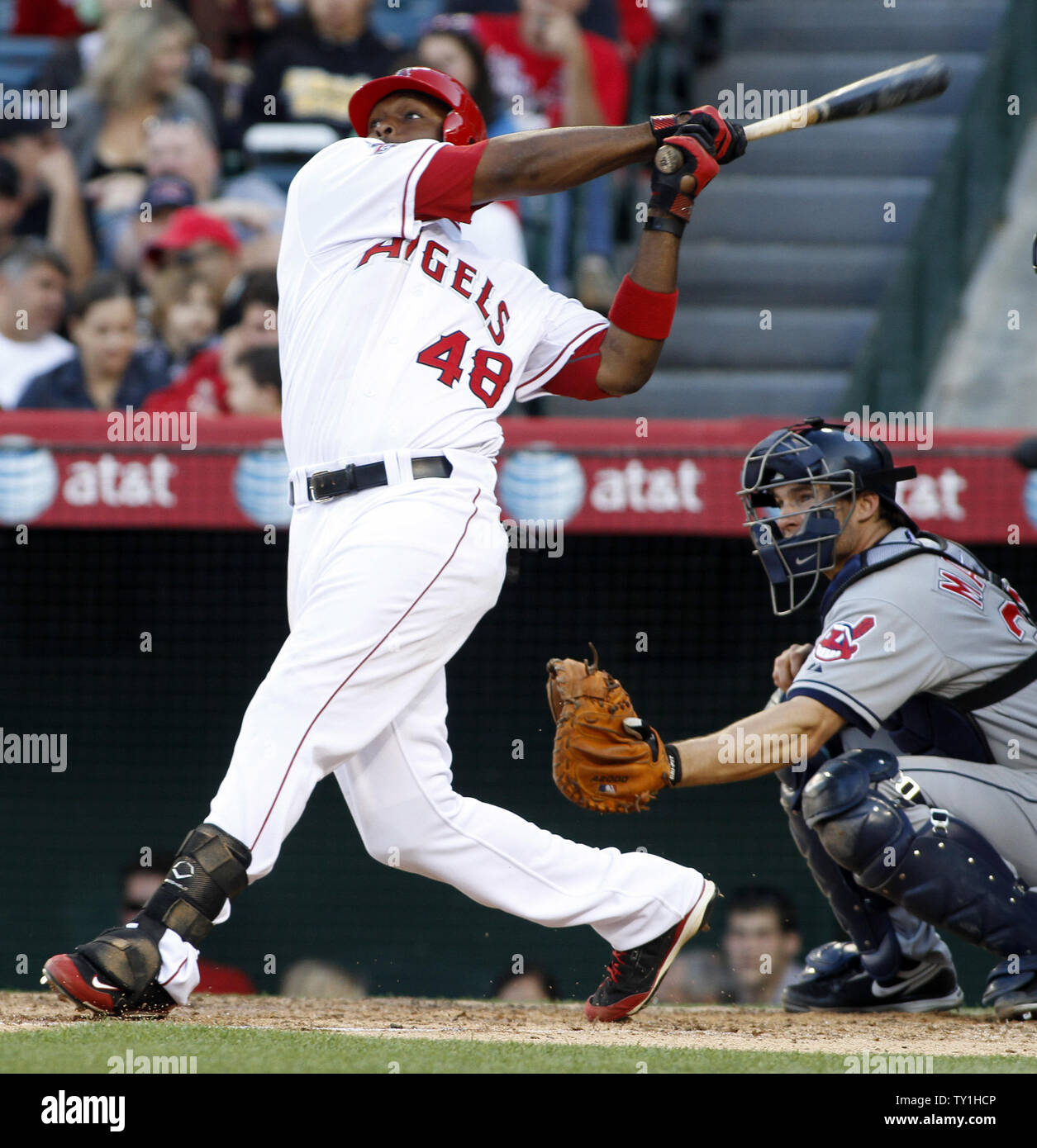 Los Angeles Angels center fielder Torii Hunter hits a 3 run home run in the sixth inning as Cleveland Indians catcher Lou Marson catches at Angel Stadium in Anaheim, California on April 28, 2010.    UPI/Lori Shepler. Stock Photo