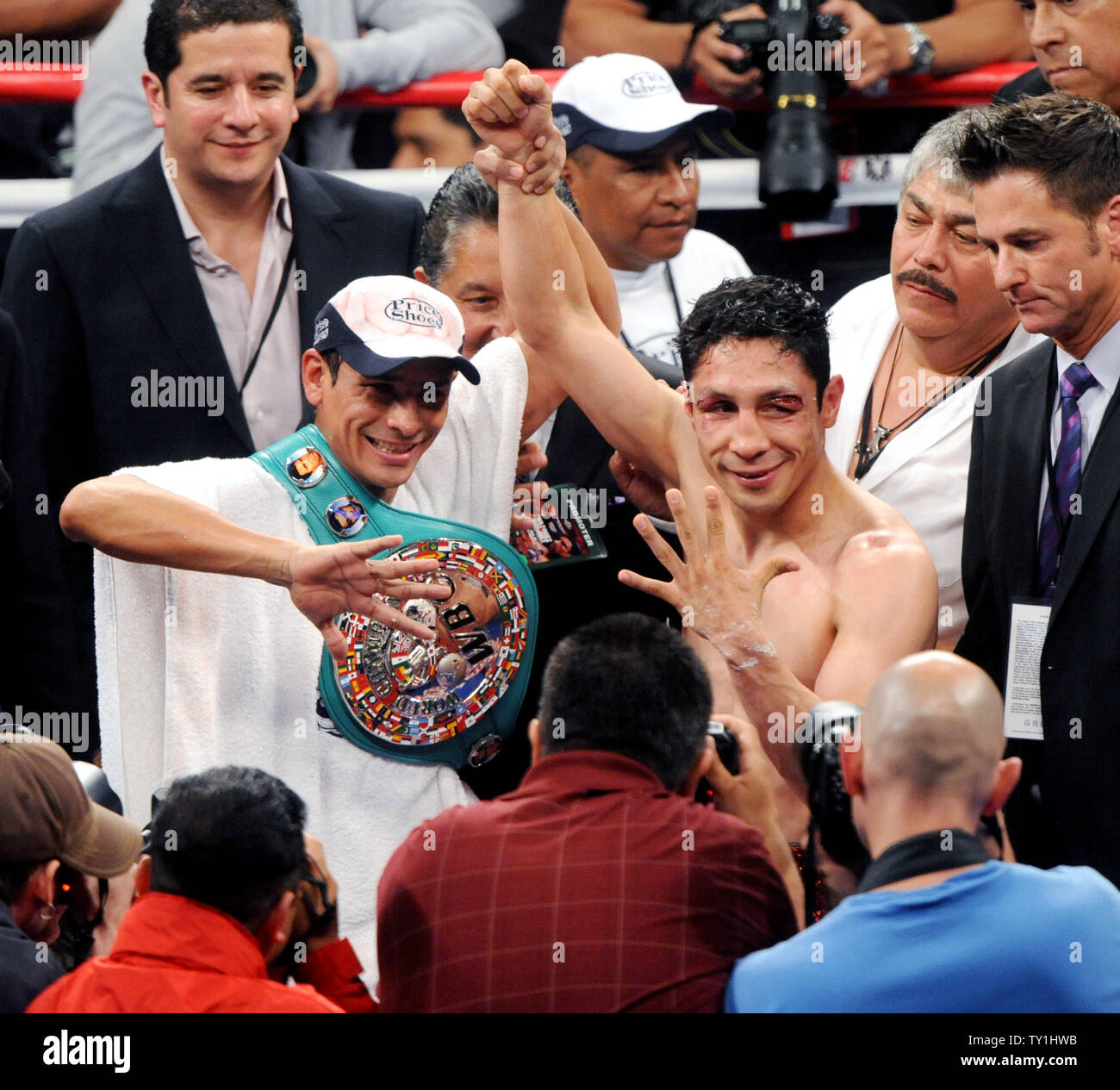 Rafael Marquez (L) celebrates his third round TKO of Israel Vazquez (R) after delivering pounding blows that first opened a grisly gash over Vazquez's left eye in the second round at Staples Center in Los Angeles on May 22, 2010. He then knocked down Vazquez early in the third, finishing him at the 1:33 mark.     UPI/Jim Ruymen Stock Photo