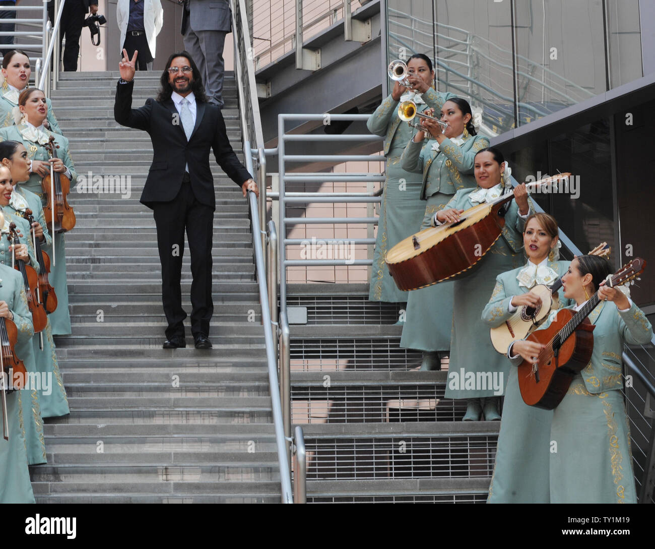 Mexican singer Marco Antonio Solis acknowledges fans as he arrives to