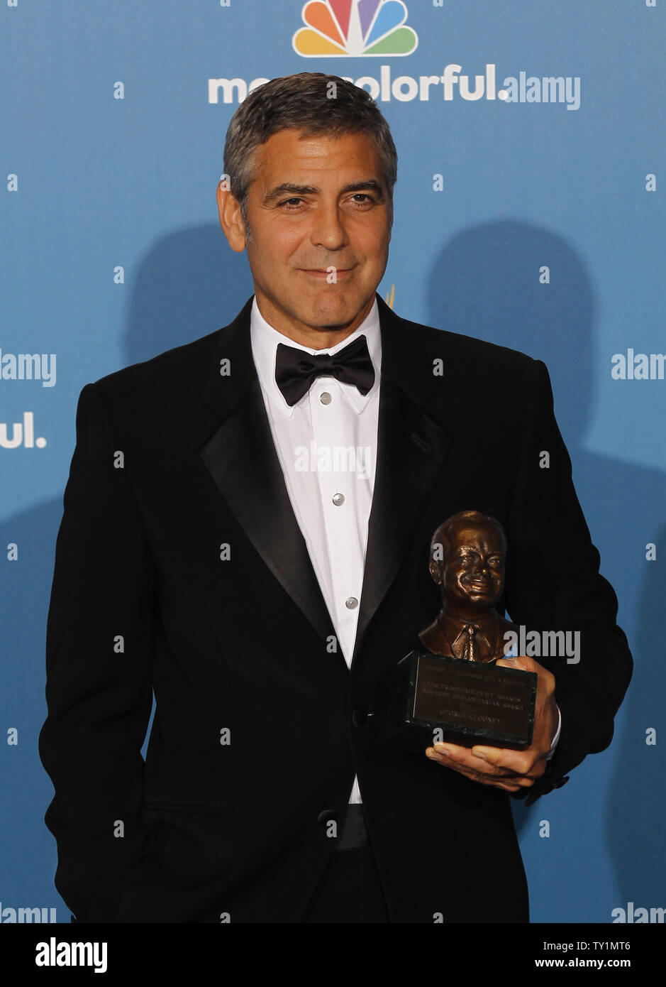 Clooney holds the Bob Hope Humanitarian Award he was given at(05)