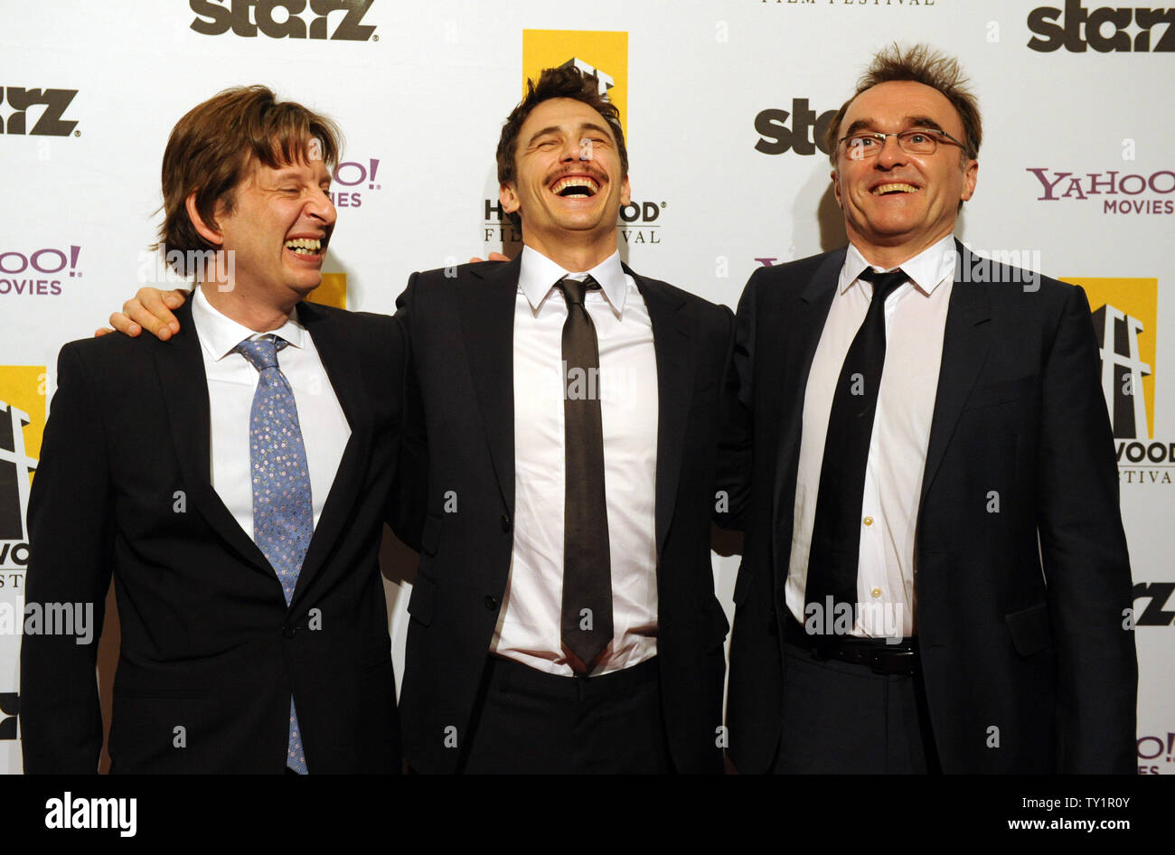 Chris Colson, James Franco and Danny Boyle, (L-R), recipients of the  Producer Award, arrive on the red carpet for the 14th annual Hollywood Film  Festival Awards presented by Starz Entertainment at the