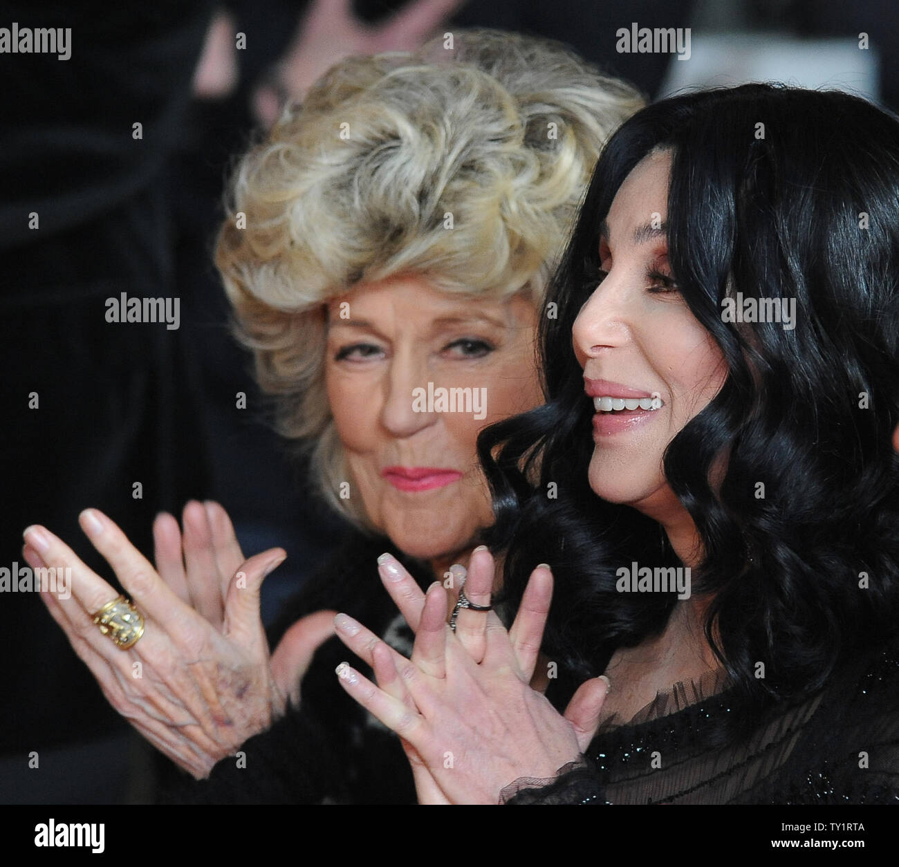 Cher and her mother Georgia Holt listen to comments before Cher added her hands and footprints to the famous impressions set in concrete, during a ceremony in the forecourt of the Grauman's Chinese Theatre in the Hollywood section of Los Angeles on November 18, 2010   UPI/Jim Ruymen Stock Photo