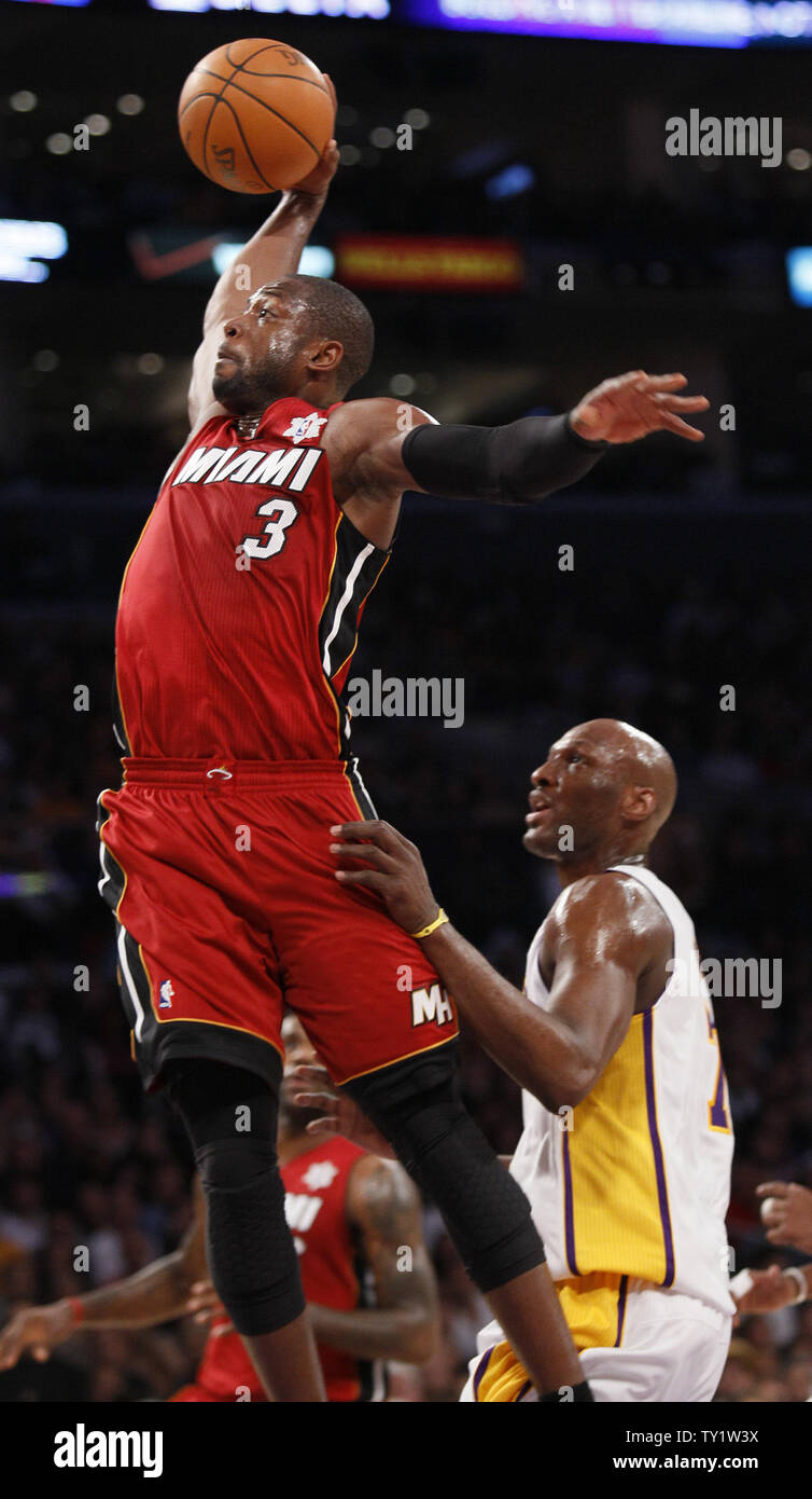 Miami Heat shooting guard Dwyane Wade (3) dunks over Los Angeles Lakers power forward Lamar Odom (7) in the first half of  their NBA basketball game in Los Angeles on December  25, 2010.   UPI/Lori Shepler Stock Photo