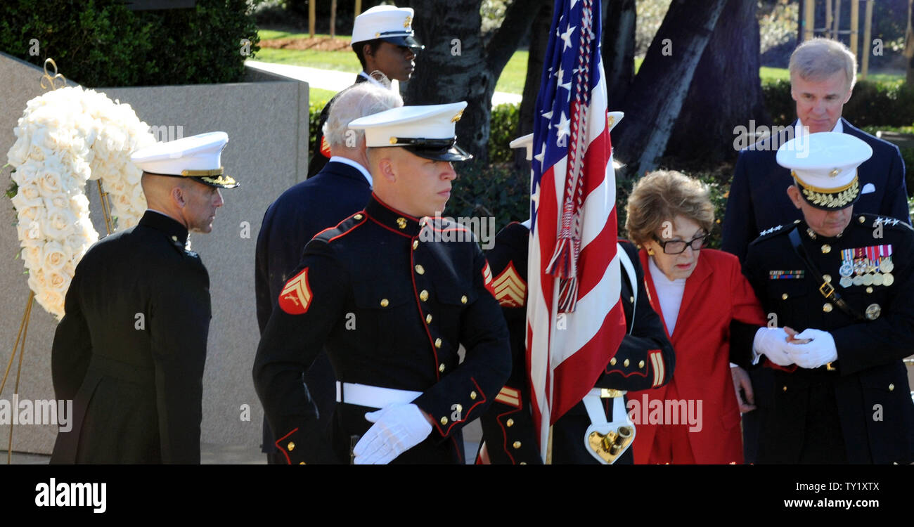 Former first lady Nancy Reagan is helped by Marine Lt. Gen. George J ...