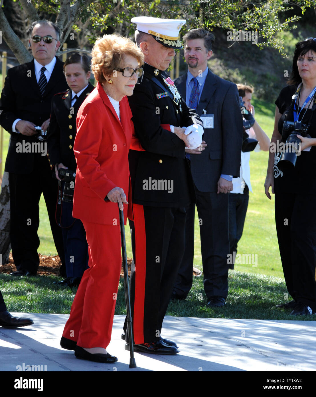 Former first lady Nancy Reagan is helped by Marine Lt. Gen. George J ...