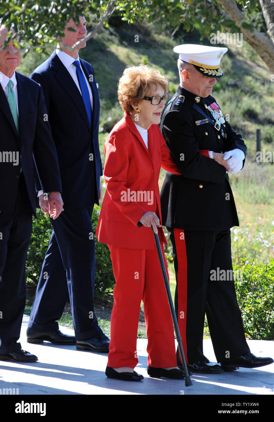Former first lady Nancy Reagan is helped by Marine Lt. Gen. George J ...