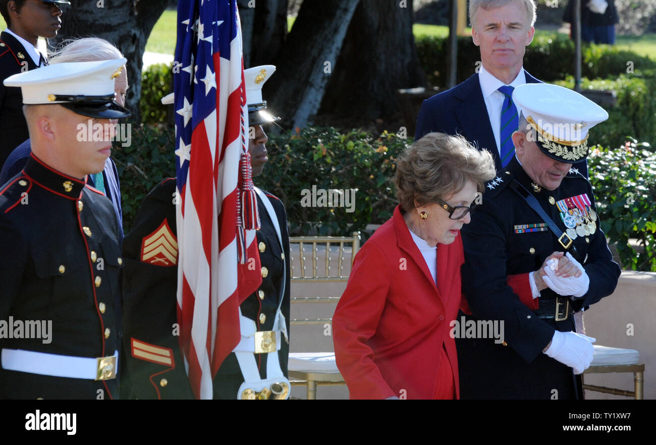 Former first lady Nancy Reagan is helped by Marine Lt. Gen. George J ...