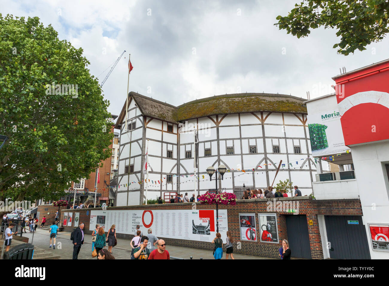 The popular restored Shakespeare's Globe Theatre on the South Bank of the River Thames Embankment, Southwark, London SE1 and tourists Stock Photo