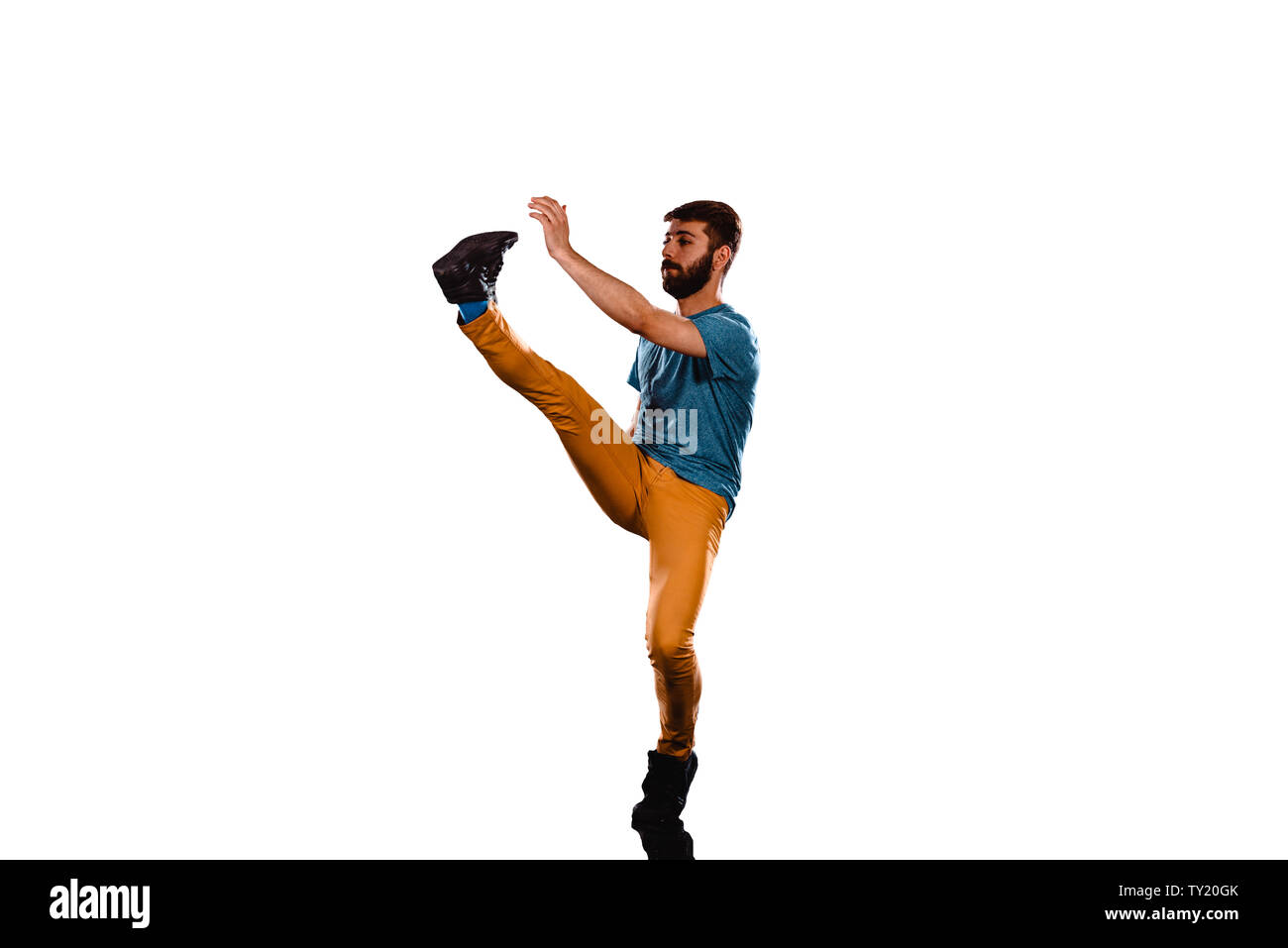 An urban guy is doing breakdance in the studio Stock Photo