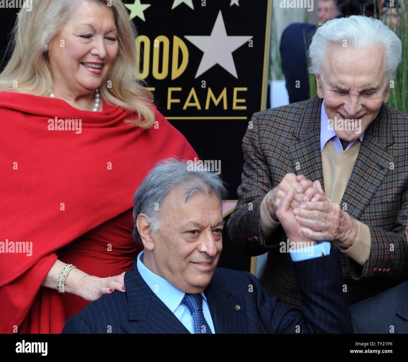 International orchestral and operatic conductor Zubin Mehta (C) is congratulated by his wife Nancy (L) and actor Kirk Douglas (R), during ceremonies honoring Mehta with the 2,434th star on the Hollywood Walk of Fame in Los Angeles on March 1, 2011. Members of the Los Angeles, Israel and Vienna Philharmonic Orchestras performed at the event.  UPI/Jim Ruymen Stock Photo