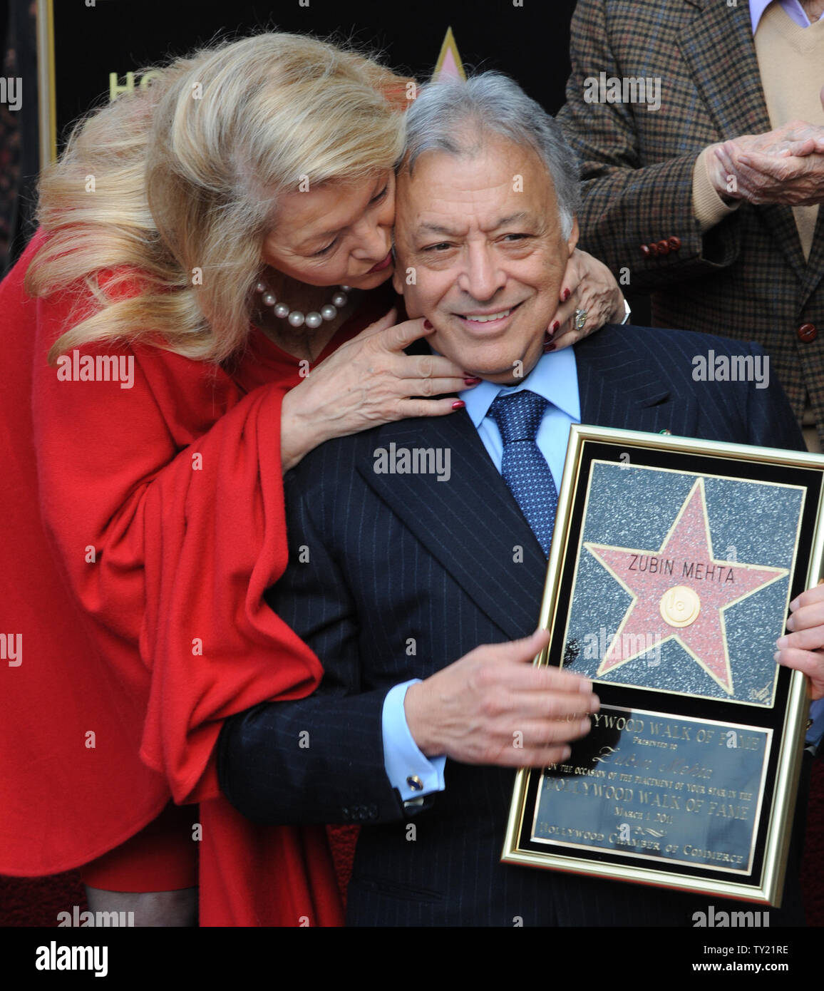 International orchestral and operatic conductor Zubin Mehta (C) is kissed by his wife Nancy (L) during ceremonies honoring Mehta with the 2,434th star on the Hollywood Walk of Fame in Los Angeles on March 1, 2011. Members of the Los Angeles, Israel and Vienna Philharmonic Orchestras performed at the event.  UPI/Jim Ruymen Stock Photo