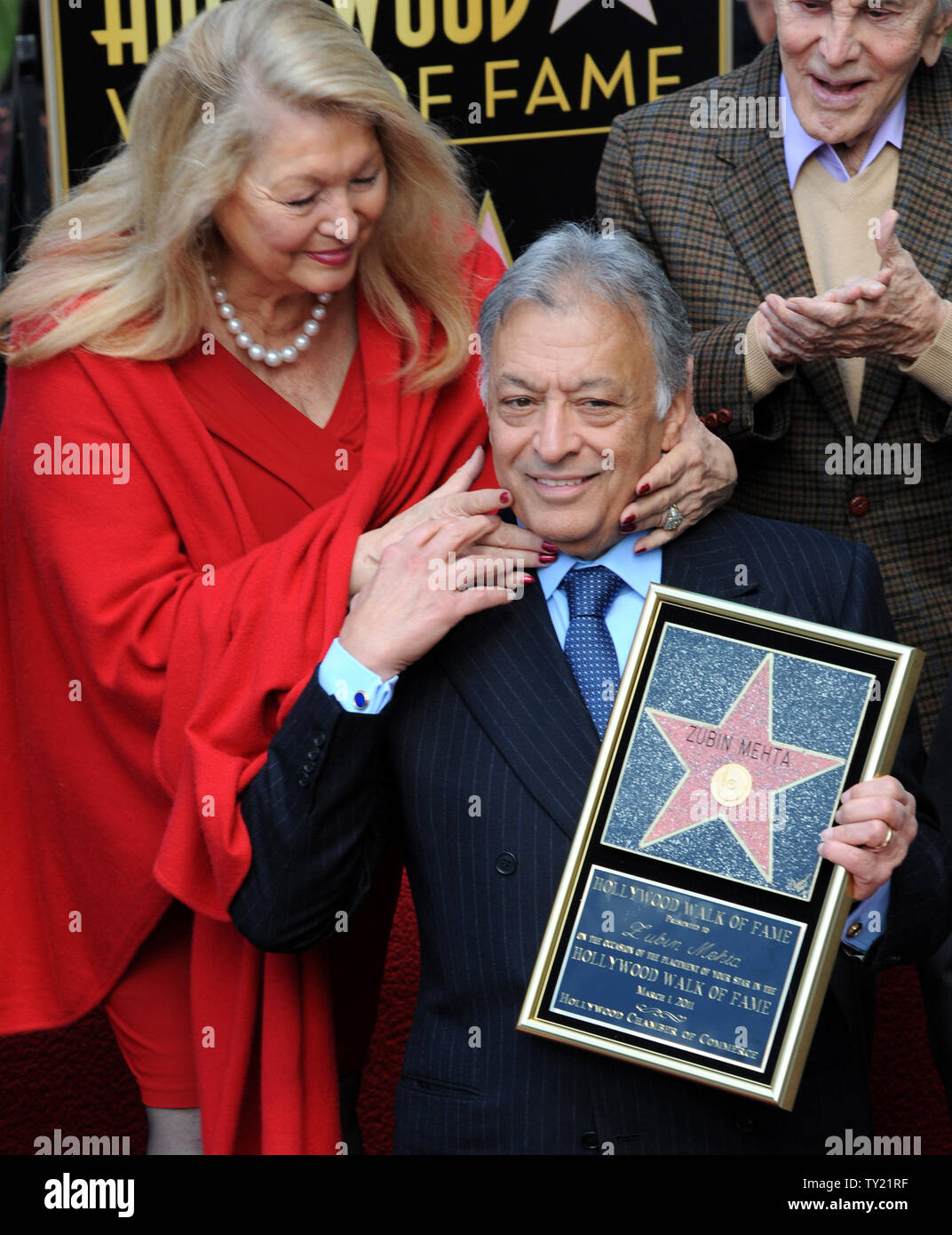 International orchestral and operatic conductor Zubin Mehta (C) is hugged by his wife Nancy (L) during ceremonies honoring Mehta with the 2,434th star on the Hollywood Walk of Fame in Los Angeles on March 1, 2011. Members of the Los Angeles, Israel and Vienna Philharmonic Orchestras performed at the event.  UPI/Jim Ruymen Stock Photo