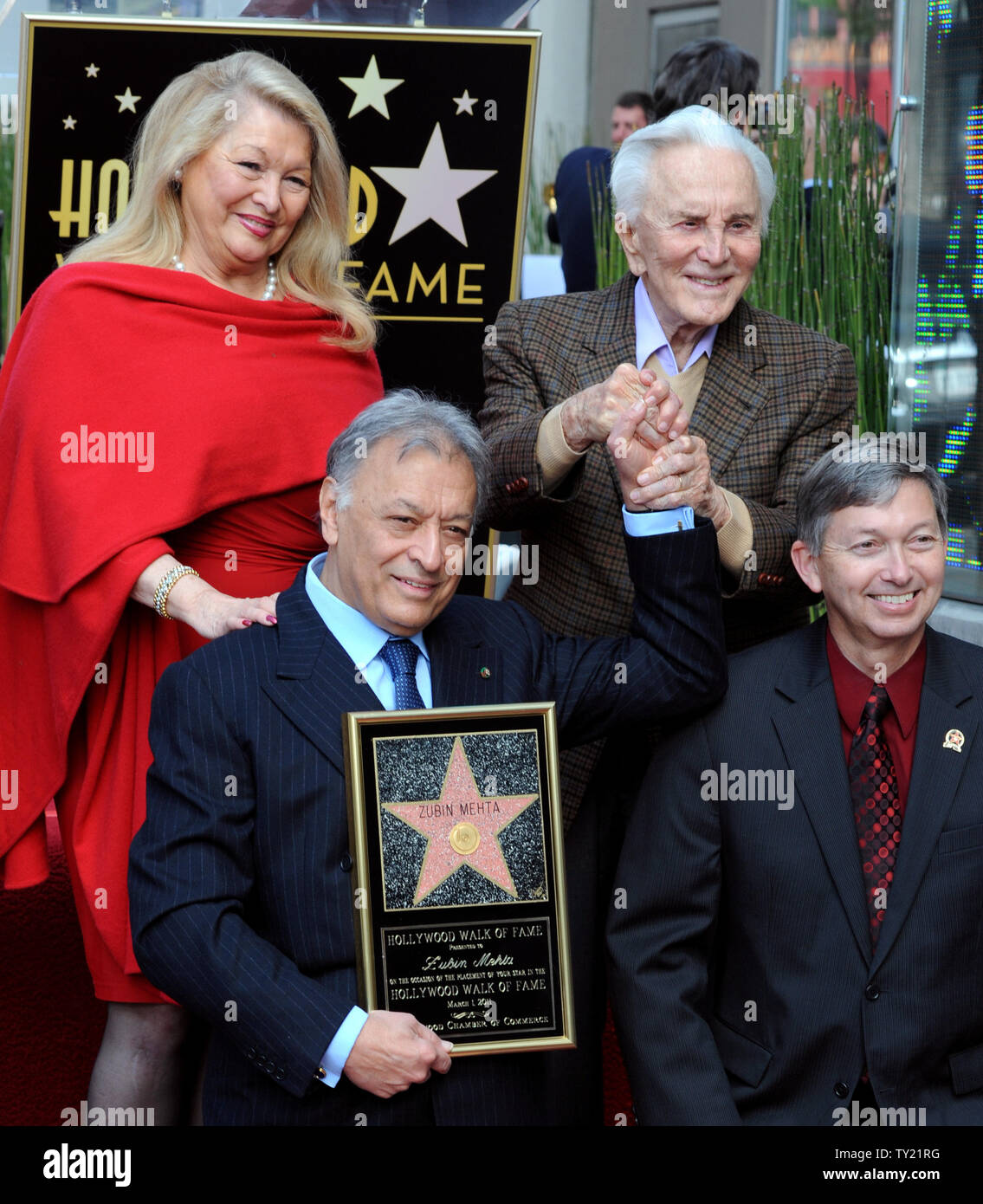 International orchestral and operatic conductor Zubin Mehta holds hands with friend, actor Kirk Doulas during ceremonies honoring Mehta with  the 2,434th star on the Hollywood Walk of Fame in Los Angeles on March 1, 2011. With Mehta is his wife Nancy (L) and Leron Gubler, lower right, president of the Hollywood Chamber of Commerce.  UPI/Jim Ruymen Stock Photo