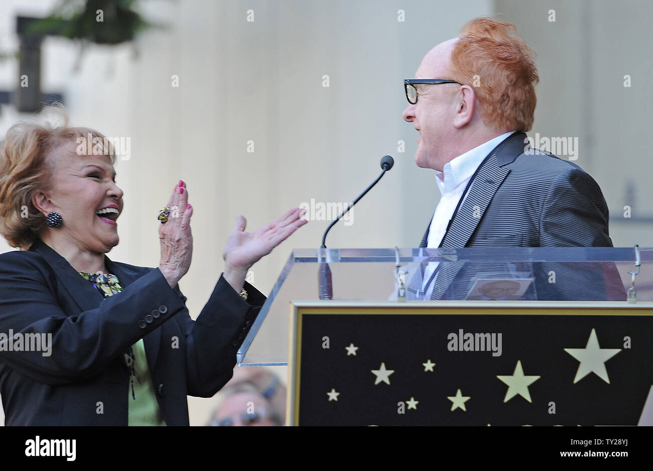 The late Buddy Holly received a posthumous star on Hollywood's Walk of Fame on his 75th birthday on Vine Street in front of The Capitol Records Building in Los Angeles on September 7, 2011. His widow, Maria Elena Holly who made a rare appearance at the event, listens as record producer Peter Asher puts on 'Buddy Holly' style glasses and says a few words.   UPI/Jayne Kamin-Oncea Stock Photo