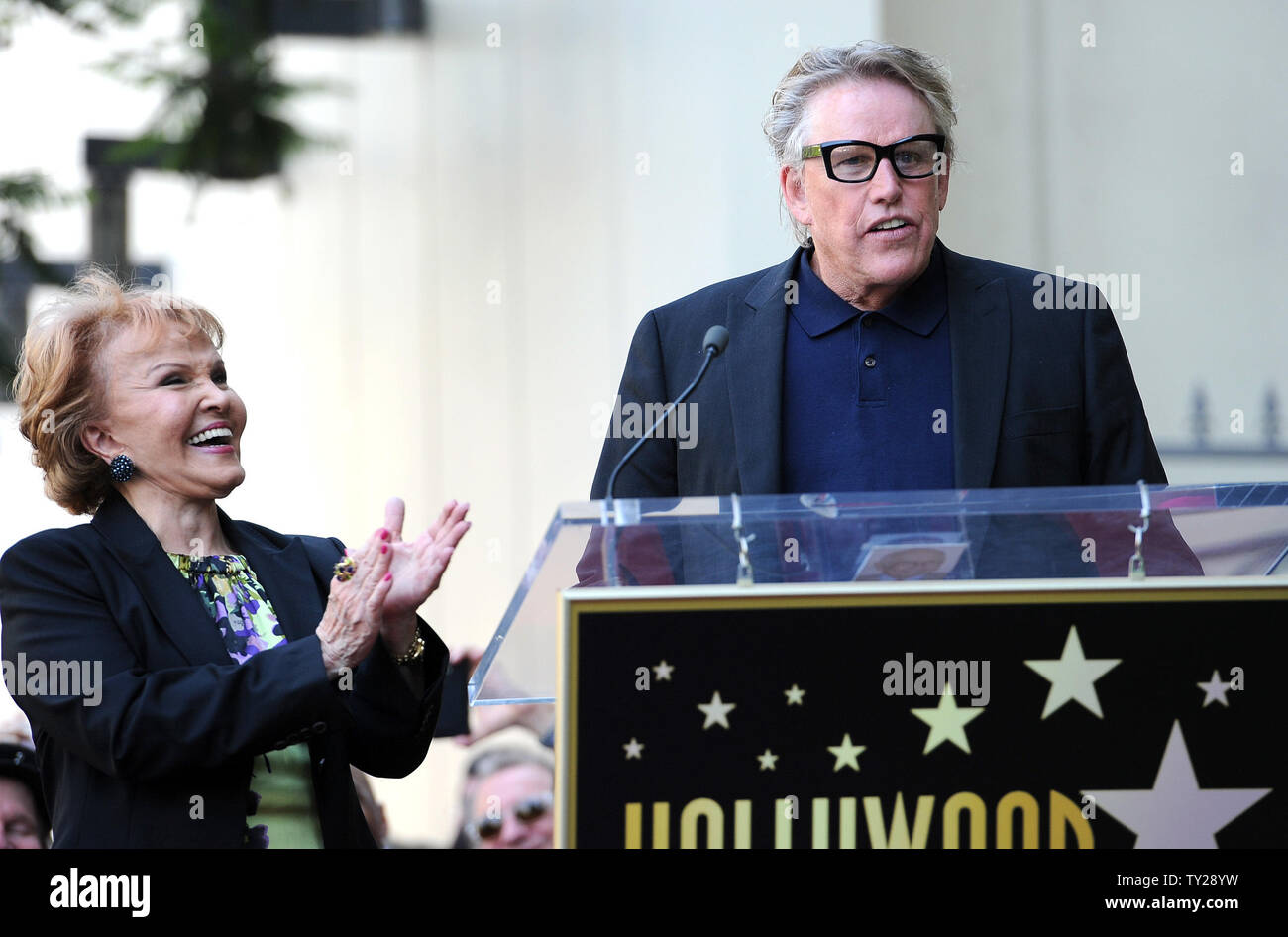 The late Buddy Holly received a posthumous Walk of Fame Star on his 75th birthday on Vine Street in front of The Capitol Records Building in Los Angeles on September 7, 2011. His widow, Maria Elena Holly who made a rare appearance at the event, listens as Gary Busey puts on 'Buddy Holly' style glasses and says a few words. Busey starred as Holly in the move The Buddy Holly Story.   UPI/Jayne Kamin-Oncea Stock Photo
