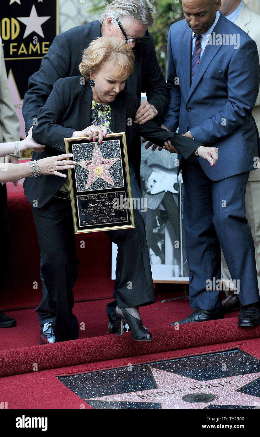 The late Buddy Holly receives a posthumous Walk of Fame Star on his 75th birthday on Vine Street in front of The Capitol Records Building in Los Angeles on September 7, 2011. His widow, Maria Elena Holly trips on the carpet as Gary Busey catches her during the star dedication ceremony.   UPI/Jayne Kamin-Oncea Stock Photo