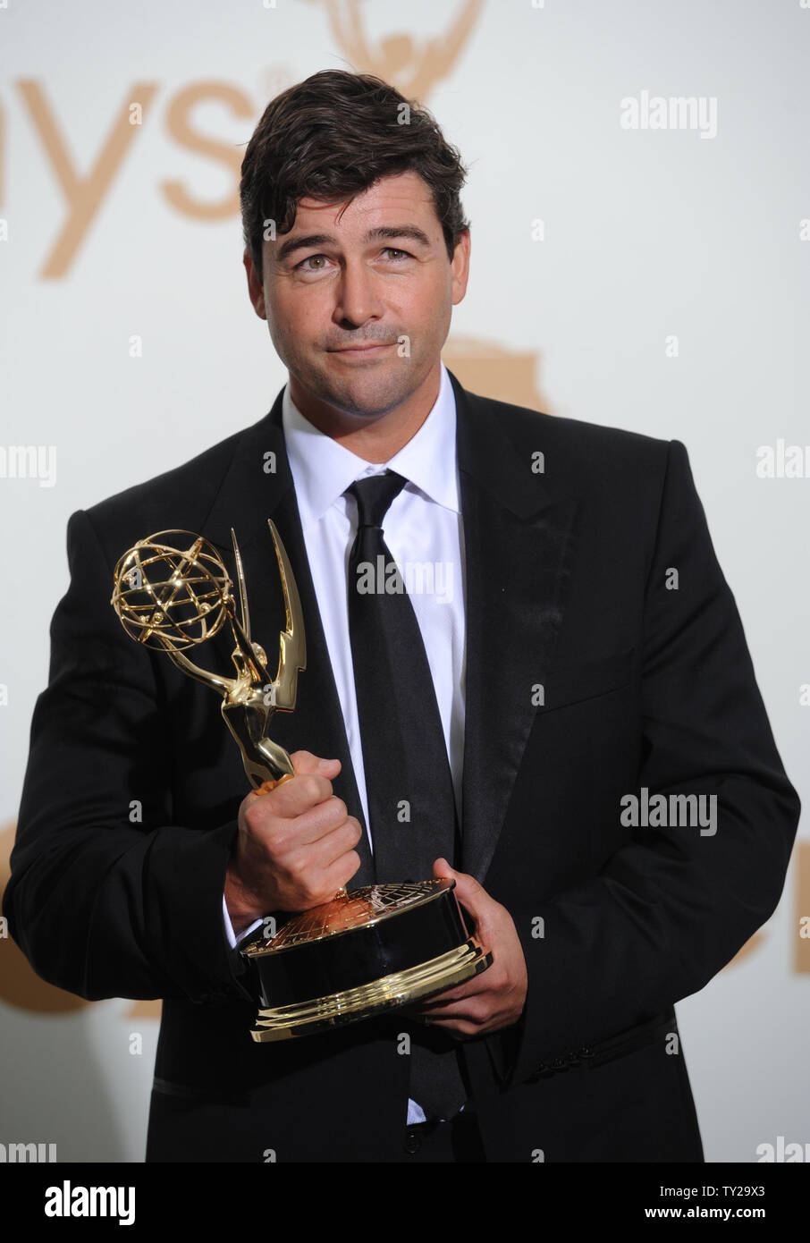 Kyle Chandler holds his Emmy for lead actor award for "Friday Night