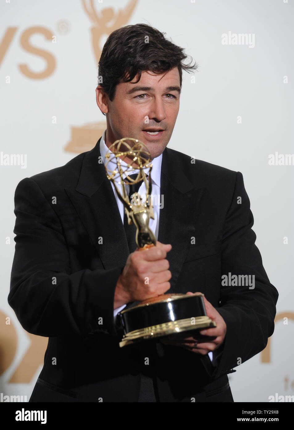 Kyle Chandler holds his Emmy for lead actor award for "Friday Night