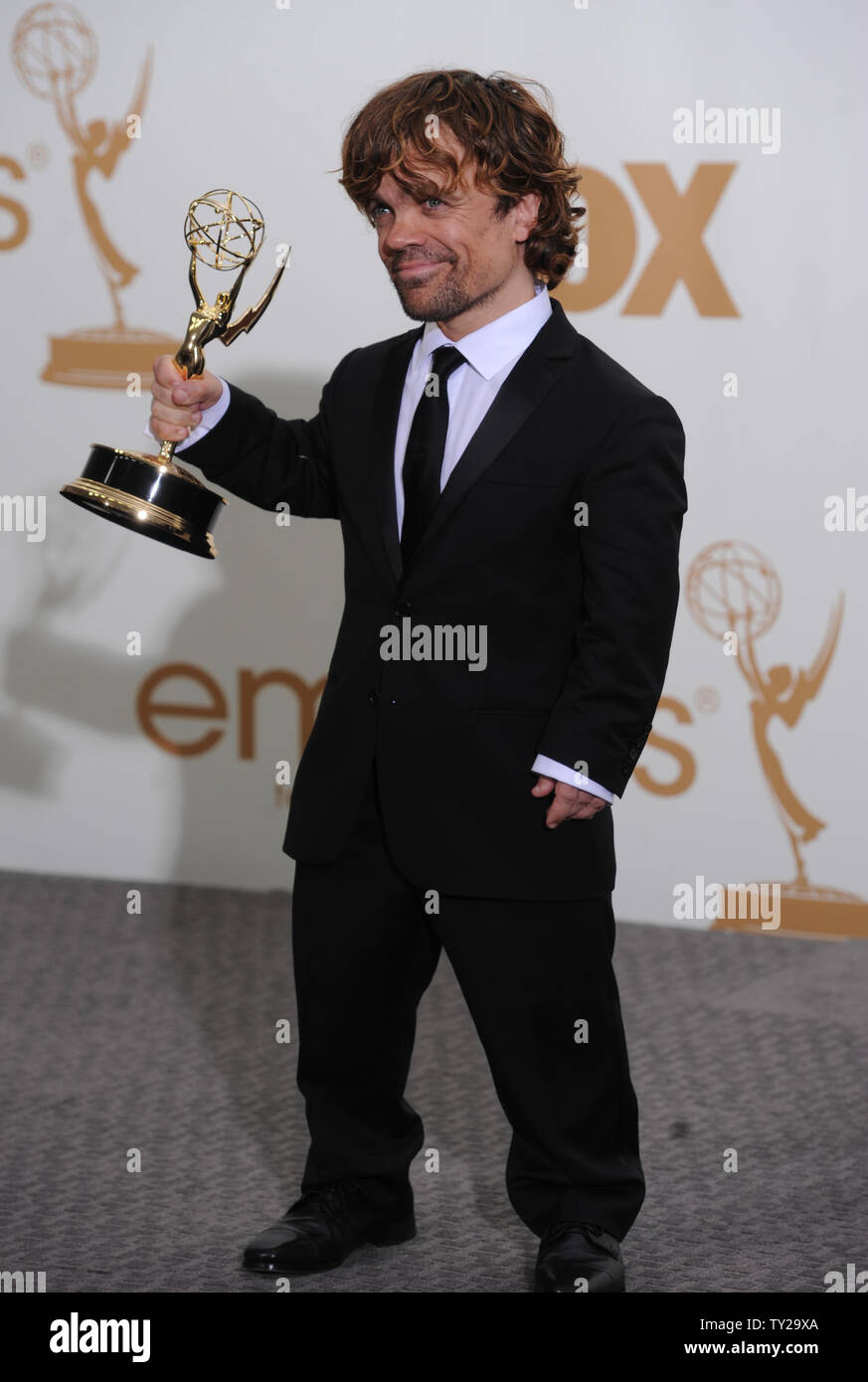 Peter Dinklage holds his award for Best Supporting Actor in a Drama Series  for "Game of Thrones" at the 63rd Primetime Emmy Awards at the Nokia  Theatre in Los Angeles on September