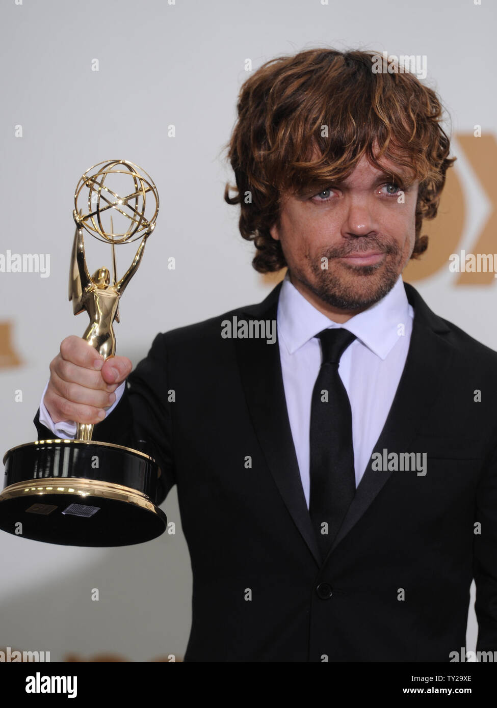 Peter Dinklage holds his award for Best Supporting Actor in a Drama Series  for "Game of Thrones" at the 63rd Primetime Emmy Awards at the Nokia  Theatre in Los Angeles on September