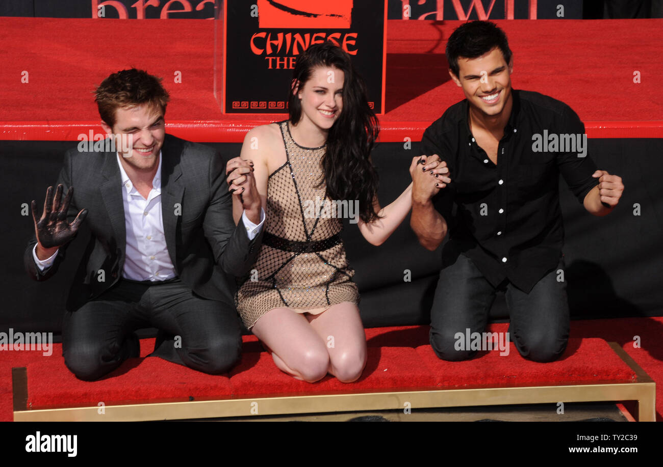 Actors Robert Pattinson, Kristen Stewart and Taylor Lautner (L-R) participate in their hand & footprint ceremony at Grauman's Chinese Theatre in the Hollywood section of Los Angeles on November 3, 2011.   UPI/Jim Ruymen Stock Photo