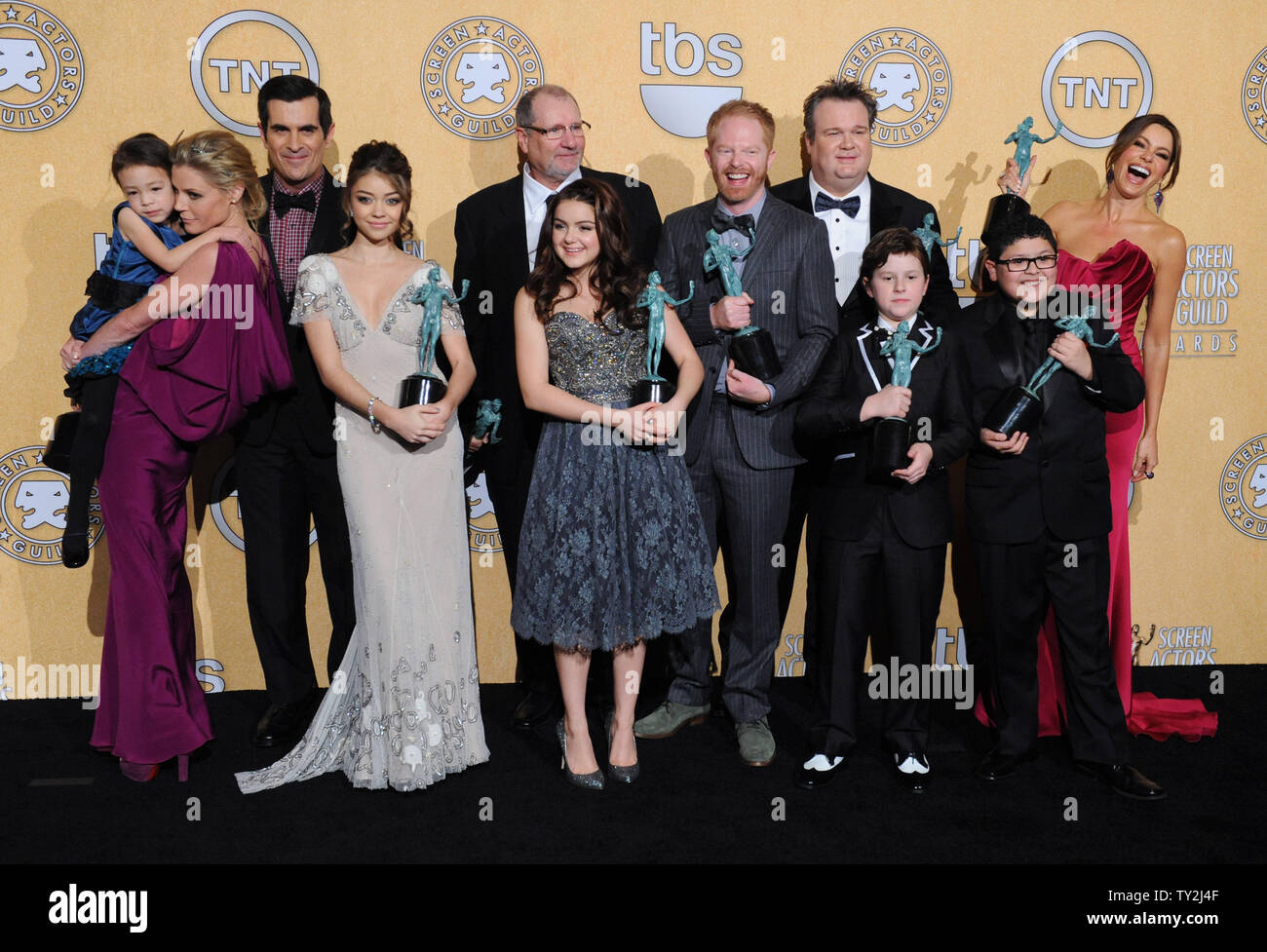 "Modern Family" cast members appear backstage with the award they