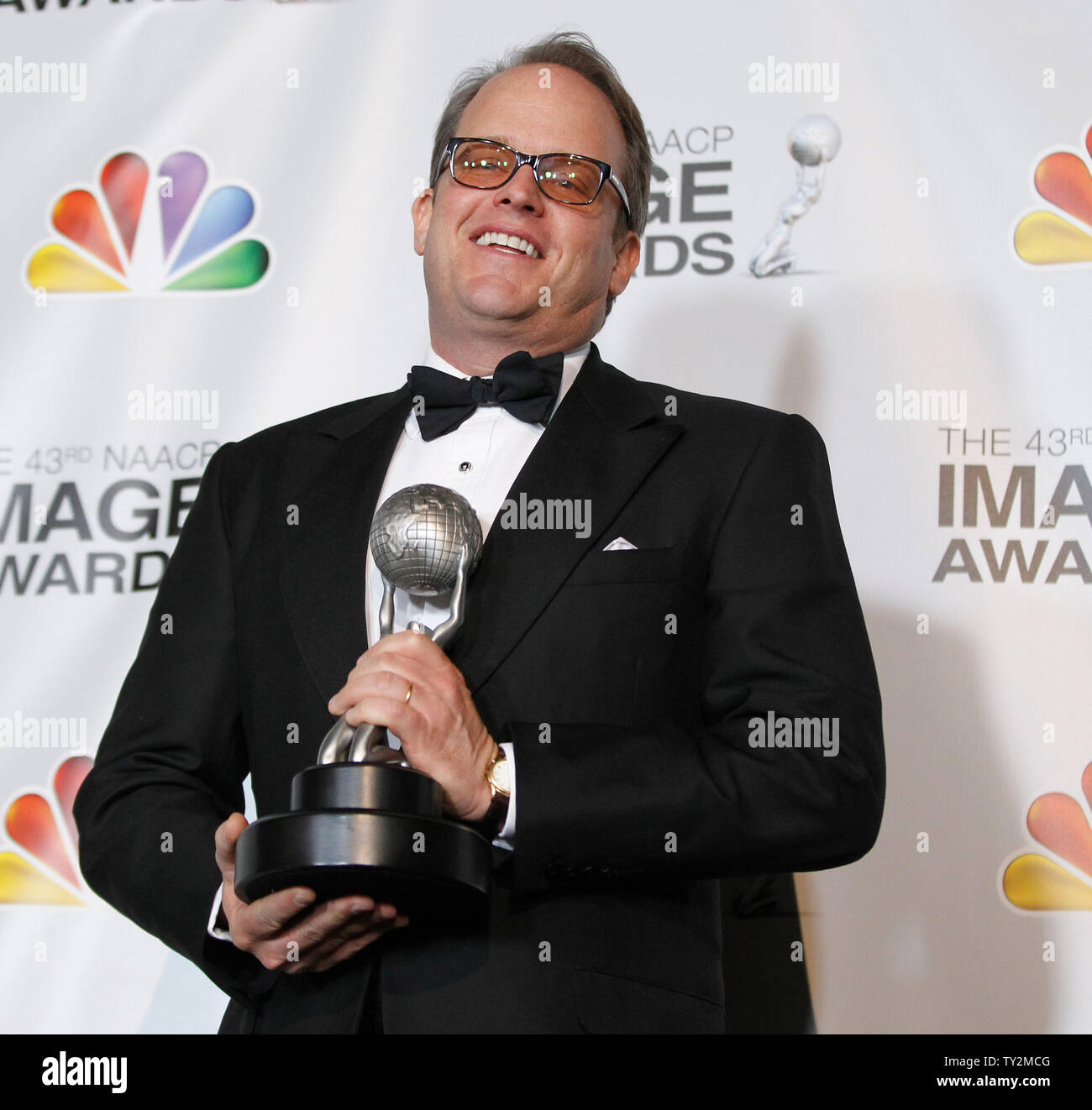 Producer Michael Stevens poses with his award in the press room at the
