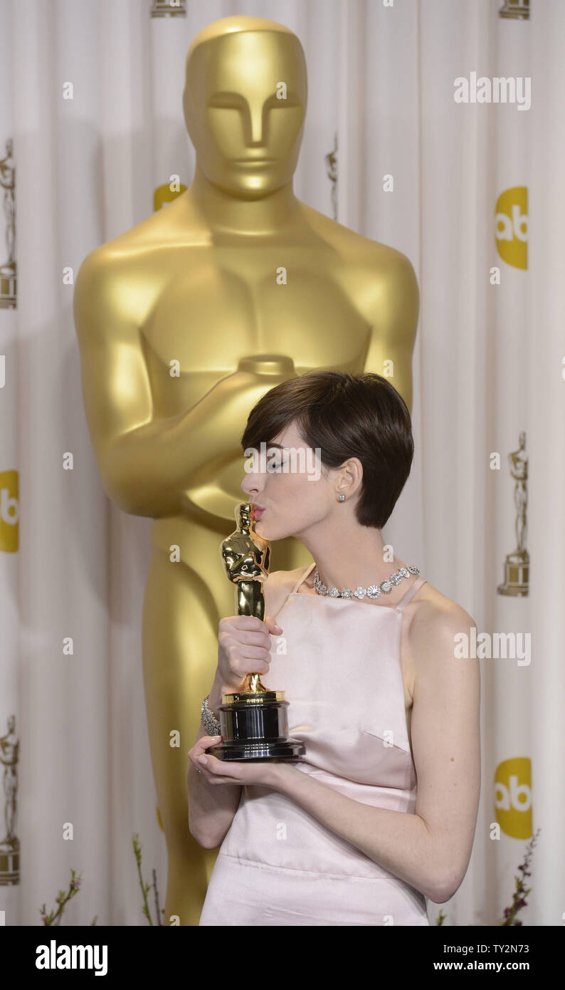 Anne Hathaway becomes emotional as she poses with her Oscar for Performance by an Actress in a Supporting Role for "Les Miserables" backstage at the 85th Academy Awards at the Hollywood and Highlands Center in the Hollywood section of Los Angeles on February 24, 2013. UPI/Phil McCarten Stock Photo